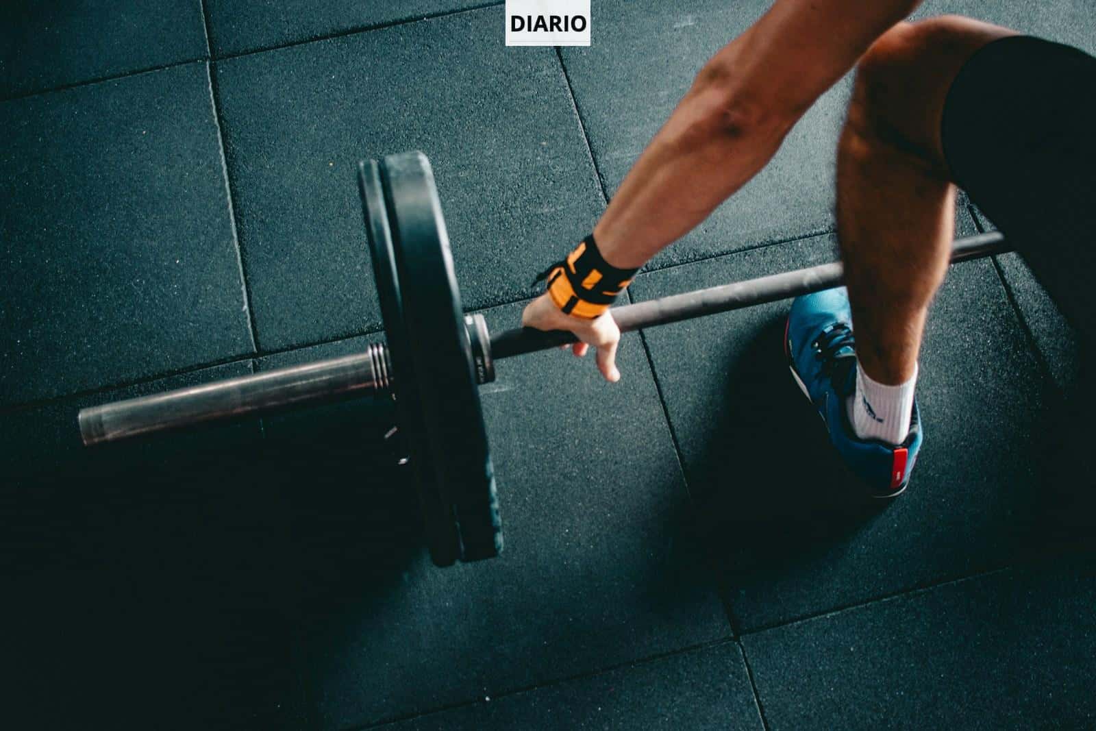 man holding black barbell