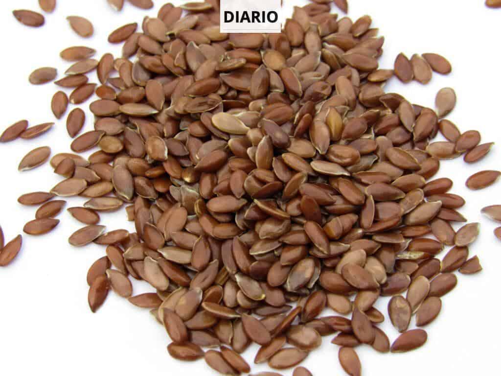 a pile of sunflower seeds on a white surface